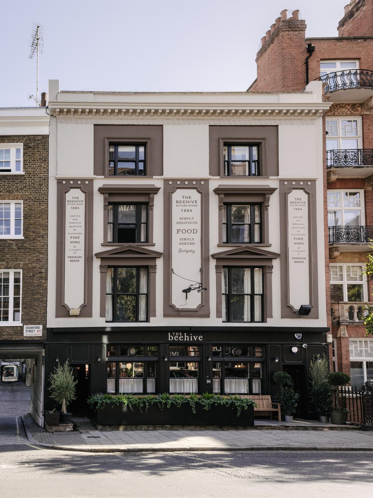 The Beehive pub's painted facade and black shopfront on Crawford Street, Marylebone